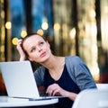 Portrait of a sleek young woman, using laptop computer