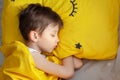 Portrait Sleeping child on soft light background. Little boy sleeping in yellow bed