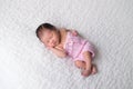 Newborn Baby Girl Wearing a Pink Romper Royalty Free Stock Photo