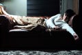 Portrait of sleeping lazy man on vintage sofa in the living room Royalty Free Stock Photo