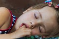 Portrait of sleeping pretty child girl who sucks her finger while sleeping. Royalty Free Stock Photo