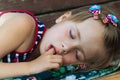 Portrait of sleeping pretty child girl who sucks her finger while sleeping. Royalty Free Stock Photo