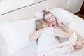 Portrait of a sleeping young couple on a bed with white bedding. Pandemic and Isolation and Quarantine Concept. Sleep as Royalty Free Stock Photo