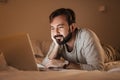 Portrait of a sleepy man using laptop computer Royalty Free Stock Photo