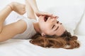 Portrait of a sleepy young woman laying in bed