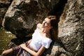 Portrait of slender young woman on stones near the sea Royalty Free Stock Photo