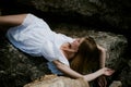 Portrait of slender young woman on stones near the sea Royalty Free Stock Photo