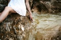 Portrait of slender young woman on stones near the sea Royalty Free Stock Photo