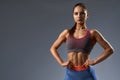 Portrait of slim female posing at camera in sportswear