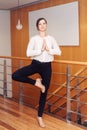 Portrait of slim fit sporty young white Caucasian business woman meditating doing yoga exercises Royalty Free Stock Photo