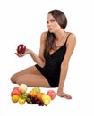 Portrait of slim fitness cheerful girl in studio with set of fruit and vegetables over white background. Healthy eating, diet, fit Royalty Free Stock Photo
