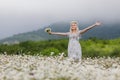 Portrait of slim girl in light dress in chamomile field Royalty Free Stock Photo