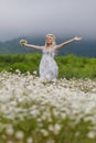 Portrait of slim girl in light dress in chamomile field Royalty Free Stock Photo