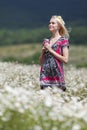 Portrait of slim girl in light dress in chamomile field Royalty Free Stock Photo