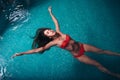 Portrait of slim young woman relaxing in swimming pool floating on back Royalty Free Stock Photo