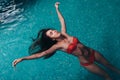 Portrait of slim young woman relaxing in swimming pool floating on back Royalty Free Stock Photo