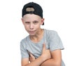Portrait of a sly squinting teenage boy in a baseball cap, isolated on white background.