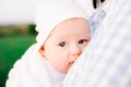 Portrait of a small baby looking at the camera with his big blue eyes, in the rays of the setting sun Royalty Free Stock Photo