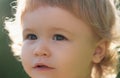 Portrait of a small blond boy, closeup. Cute kids cropped face. Positive emotional Baby child.