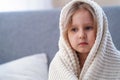 Portrait small blonde girl wrapped in blanket Royalty Free Stock Photo