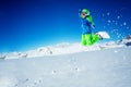 Portrait of a small boy jump on snowboard over sky