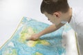 Portrait of small boy studying the map of the world Royalty Free Stock Photo