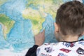 Portrait of small boy studying the map of the world Royalty Free Stock Photo