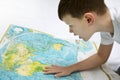 Portrait of small boy studying the map of the world Royalty Free Stock Photo