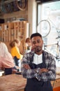 Portrait Of Small Business Owner In Workshop Assembling Hand Built Sustainable Bamboo Bicycles Royalty Free Stock Photo