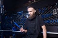 Portrait of small business owner of young man with beard. Guy bicycle mechanic workshop worker sitting with tool in his hand in a Royalty Free Stock Photo