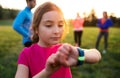 A portrait of small girl with large group of people doing exercise in nature. Royalty Free Stock Photo