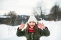 Portrait of a small girl in winter nature, wearing coat, hat and scarf. Royalty Free Stock Photo