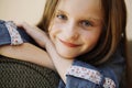 Portrait of small happy girl with long blond hair.