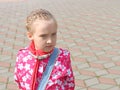 Portrait of small pensive schoolgirl