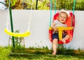 Portrait of small toddler boy swing in the garden Royalty Free Stock Photo