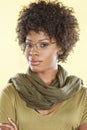 Portrait of a smart African American woman wearing glasses with a stole round her neck over colored background