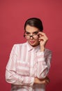 Portrait of smart attractive positive woman in glasses looking at camera