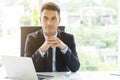 Portrait of smart businessman on desk in office. Investment and consultant concept