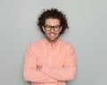 portrait of smart casual man with curly hair and glasses crossing arms Royalty Free Stock Photo