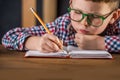 Portrait of smart child boy drawing with pencils at lesson Hand with yellow pencil on table. Back to school. Education Royalty Free Stock Photo