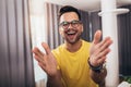 Smart confident smiling millennial man standing at home