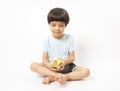 Asian kid play magic rubik cube on white background. Royalty Free Stock Photo