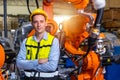 Portrait smart engineer man working with advance robotic machine weling in heavy industry