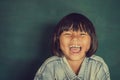 Portrait of smart girl by the blackboard happy laugh