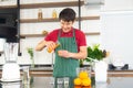 Portrait smart and handsome Asian man preparing healthy meal and fresh organic orange juice in the loft style kitchen