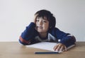 Portrait of Smart kid enjoy doing homework, Child boy looking at camera with smiling face feeling happy after finised shool