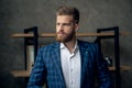 Portrait of smart responsible man with modern hairdo looking away over blurred office hurry up for meeting. Management employment Royalty Free Stock Photo