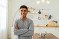 Portrait of smart smiling Caucasian man standing with arms folded at home posing for photos with copy space Royalty Free Stock Photo