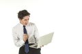 Portrait of smart young asian businessman wearing white shirt holding and looking to computer laptop clench one`s fists and