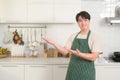 portrait of smart young Asian man smiling in kitchen at home Royalty Free Stock Photo